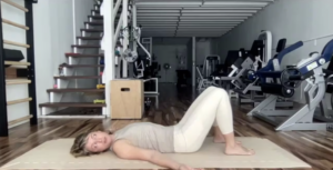 Woman doing Pilates exercises on the Pilates mat.