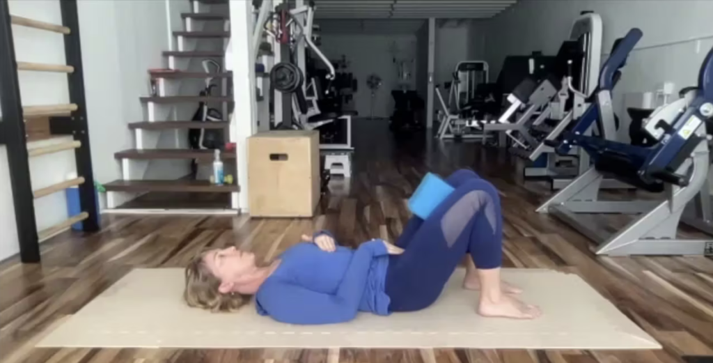 Woman doing Pilates exercises on the Pilates mat.