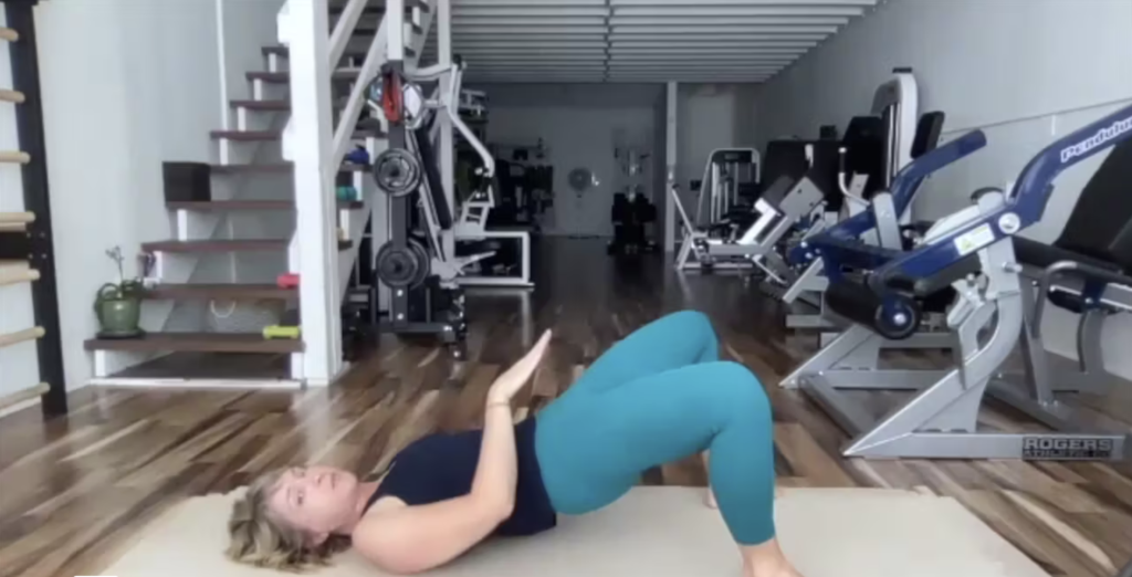 Woman doing Pilates exercises on the Pilates mat.