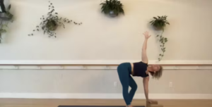 Woman doing yoga stretches on the yoga mat.