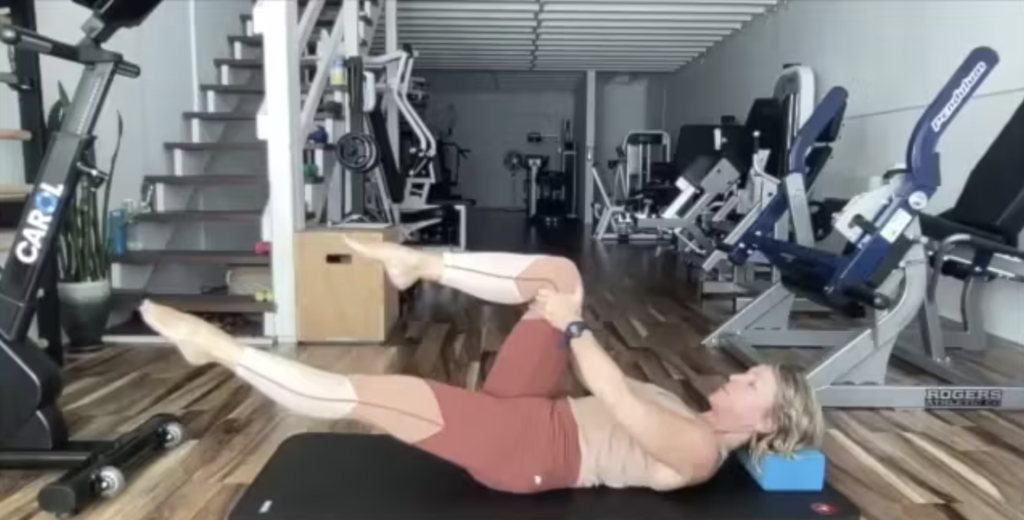 Woman doing Pilates exercises on the Pilates mat.