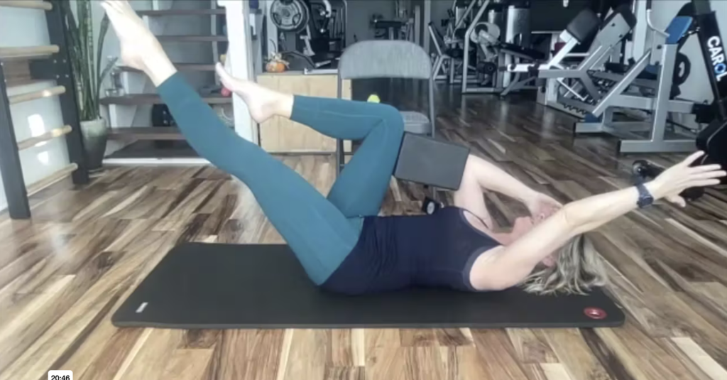 Woman doing Pilates exercises on the Pilates mat.