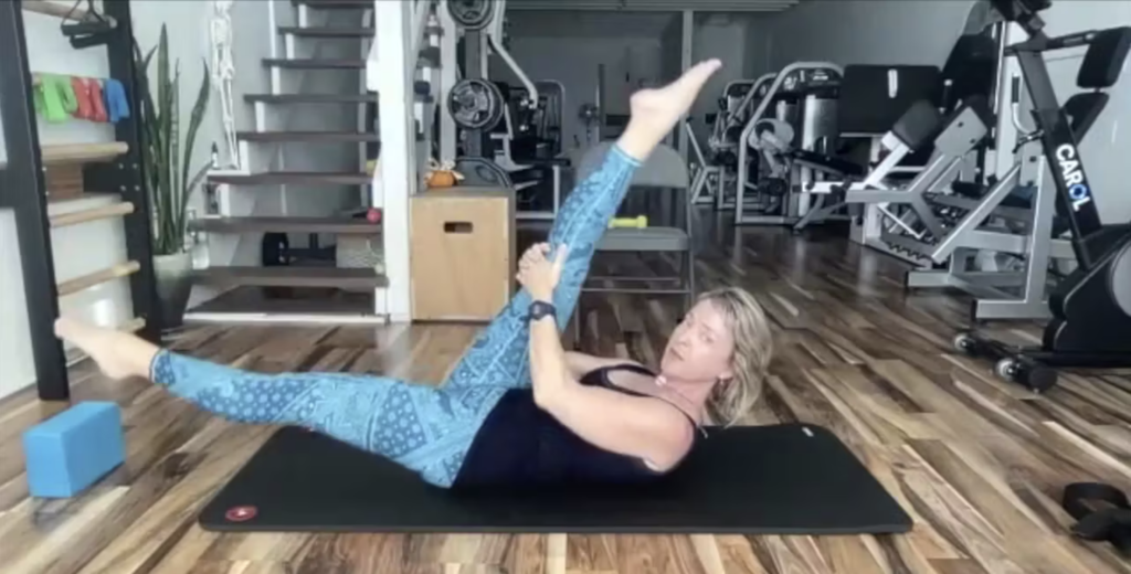 Woman doing Pilates exercises on the Pilates mat.