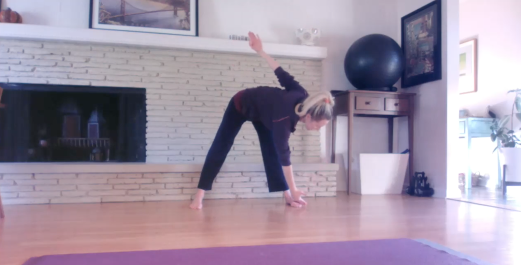 Woman doing standing Pilates exercises