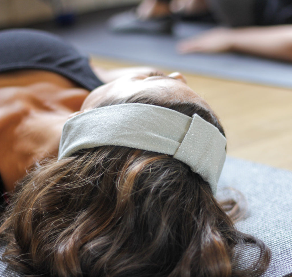 Close up of woman doing Pilates on the Pilates mat.