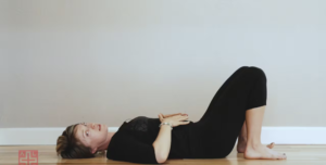 Woman teaching Pilates breathing.