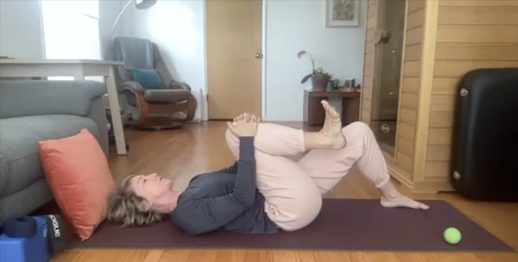 Woman doing Pilates exercises on the Pilates mat.