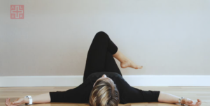 Woman doing Pilates exercises against a wall.