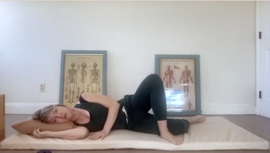 Woman doing Pilates exercises on a mat.