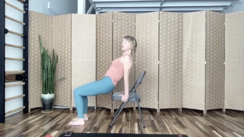 Woman doing Pilates exercises with a chair.