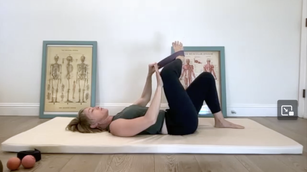 Woman doing Pilates exercises on a mat.