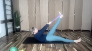 Woman doing Pilates exercises on a mat.