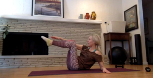 Woman doing Pilates exercises on a Pilates mat.