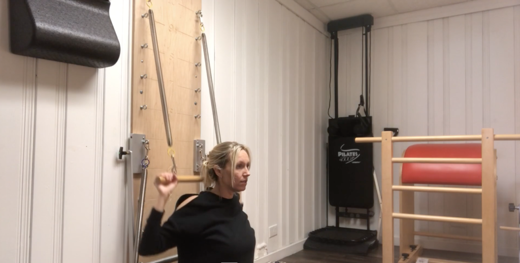 Woman doing Pilates exercises in a Pilates studio.