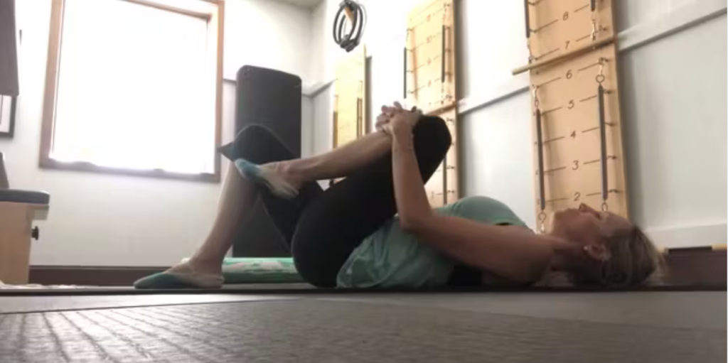 Woman doing Pilates exercises on the Pilates mat.