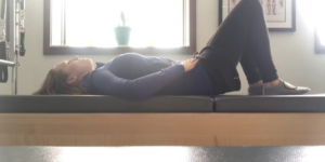 Woman doing Pilates exercises for back pain in a Pilates studio.