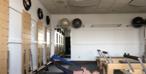 Woman doing PIlates exercises in a Pilates studio.