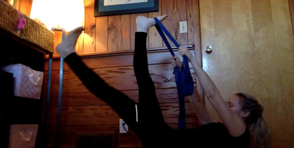 Woman doing PIlates exercises with a theraband.