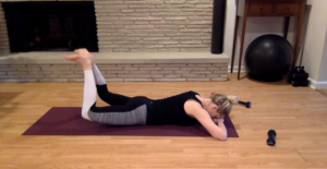 Woman doing Pilates exercises on a yoga mat.