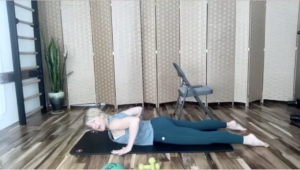 Woman doing Pilates exercises on a mat.