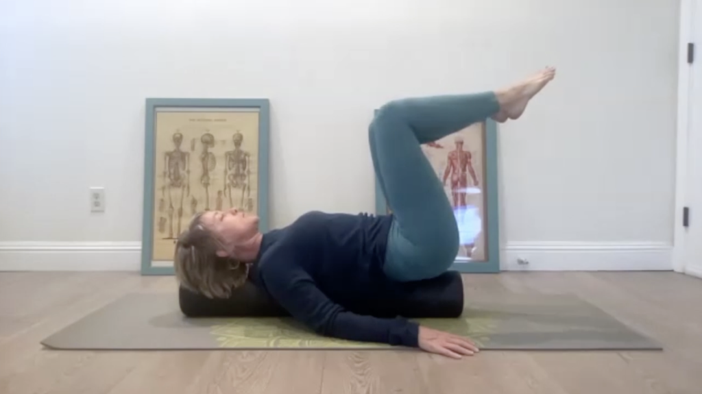 Woman doing Pilates exercises on a mat.