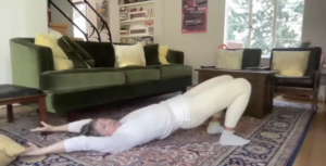 Woman doing Pilates exercises on the floor.