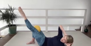 Woman doing Pilates exercises on the Pilates mat.