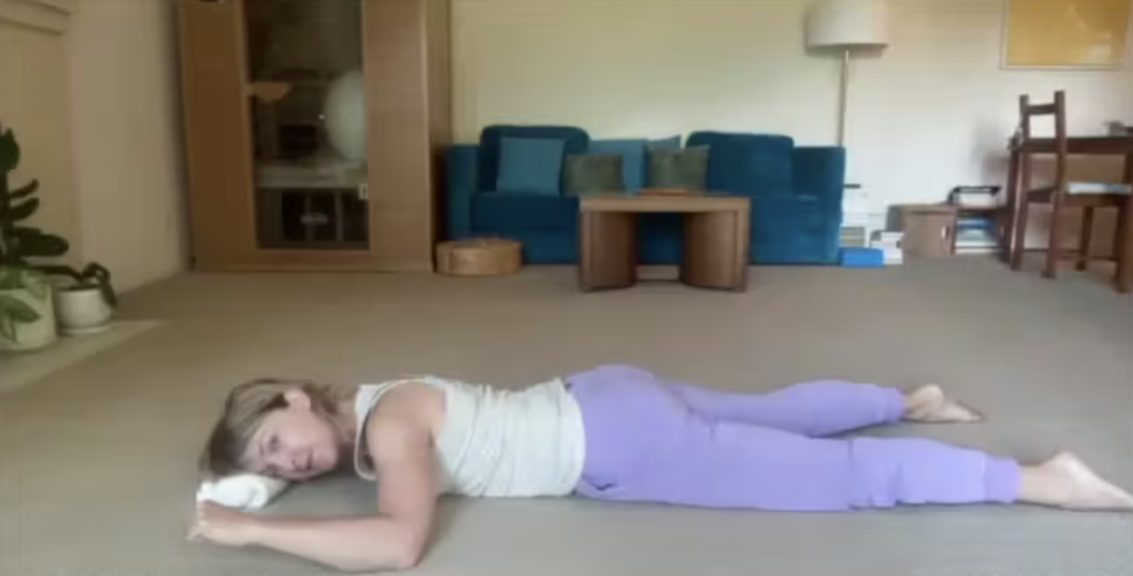 Woman doing Pilates exercises on the floor.