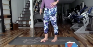 Woman doing Pilates exercises on the Pilates mat in a gym.