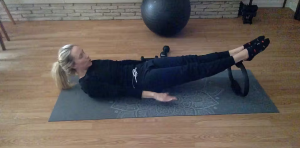 Woman doing Pilates exercises with a Pilates magic circle.