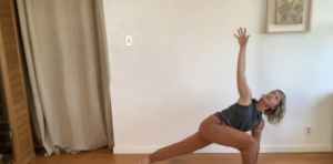 Woman doing yoga lunge stretch with arm reaching up