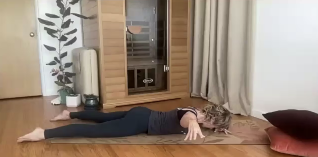 Woman doing Pilates exercises on her yoga mat.