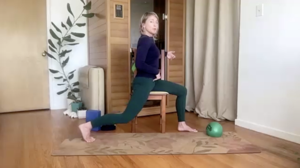 Woman doing Pilates on a chair in a lunge position