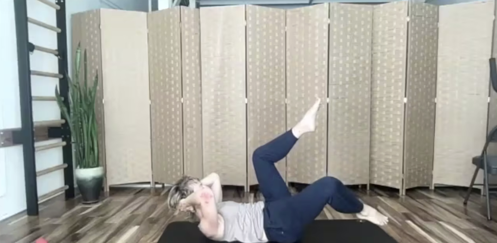 Woman doing Pilates exercises on her Pilates mat.