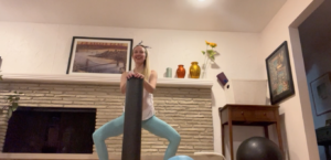 Woman doing Pilates exercises standing up in a squat position.