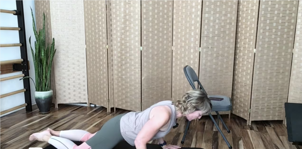 Woman on Pilates mat doing Pilates pushup exercises