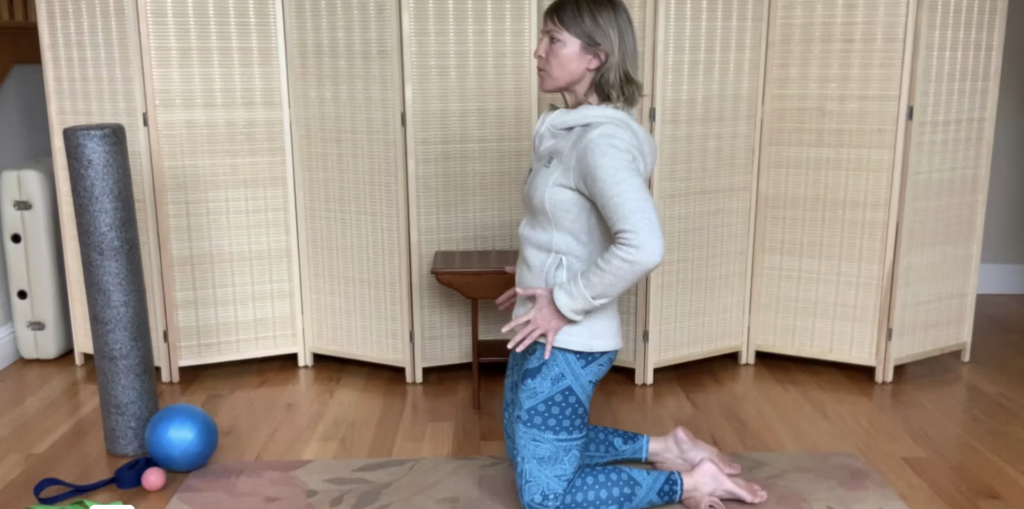 Woman on knees doing Pilates exercises