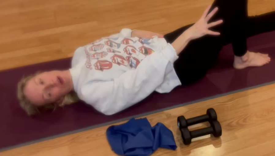 Close up of woman doing Pilates exercises on the mat.