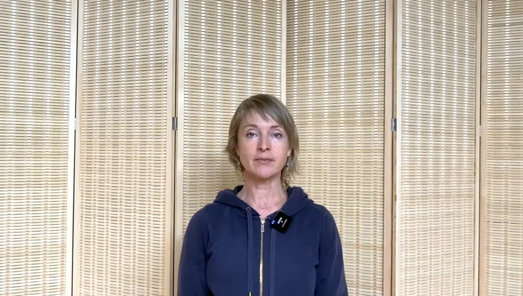 Close up of a woman doing Pilates breathing.