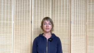 Close up of a woman doing Pilates breathing.