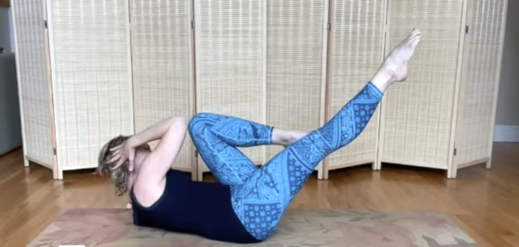 Woman doing Pilates abdominal exercises on a Pilates mat.