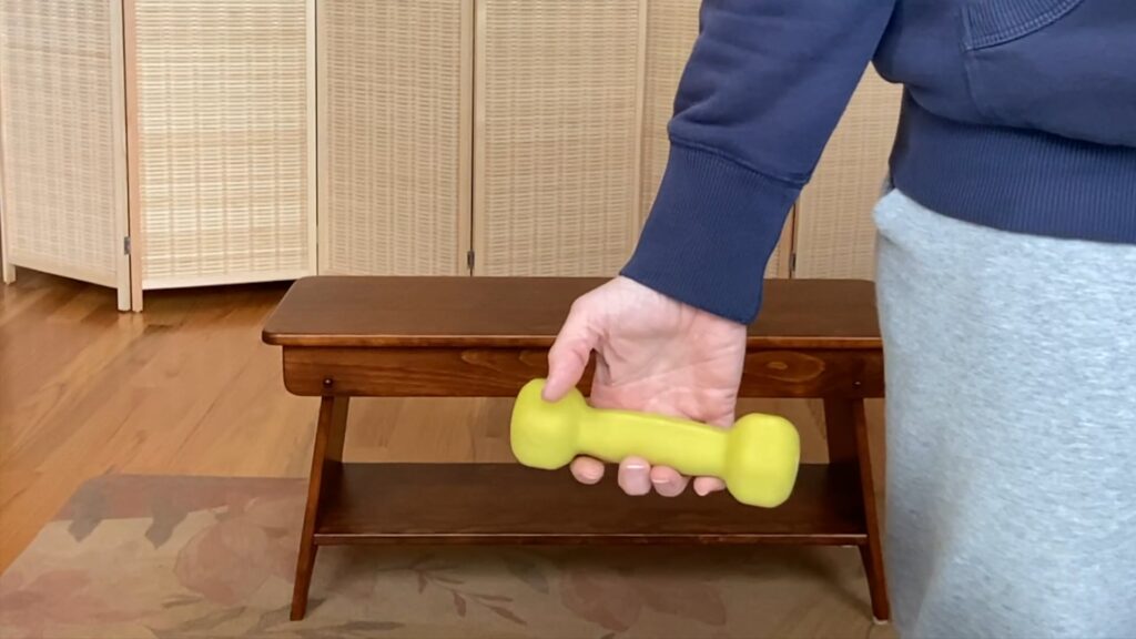 Woman holding Pilates weight in hand for fitness and strength