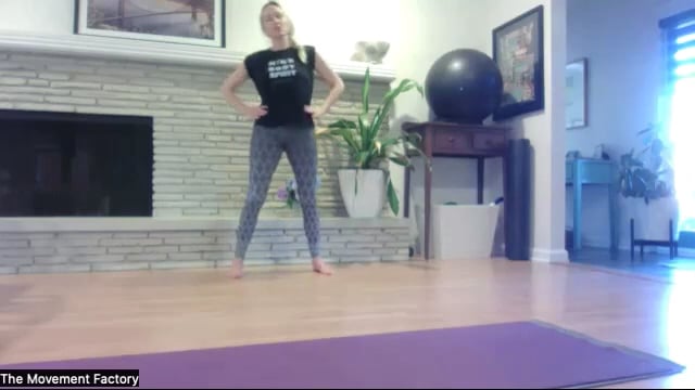 Woman doing Pilates exercises standing in front of plants and behind a Pilates mat.