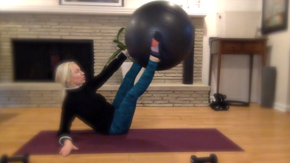 Woman doing Pilates with a big ball.