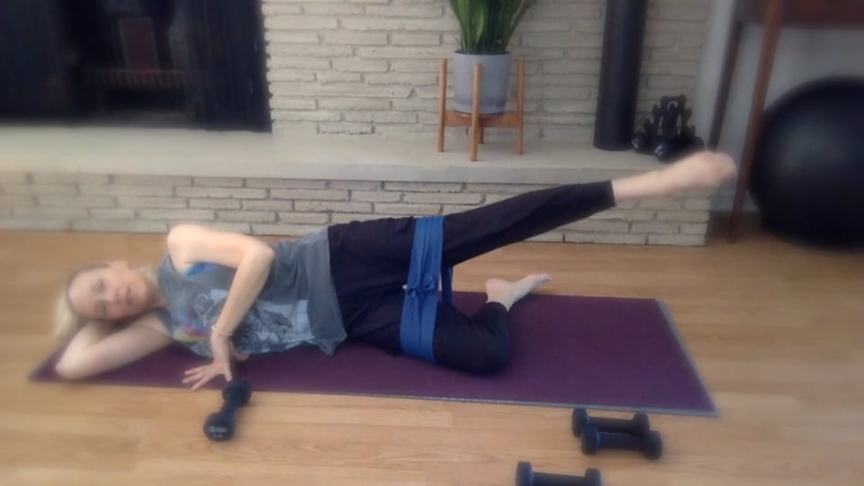 woman doing pilates on her side