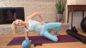 Woman doing a side plank in Pilates class