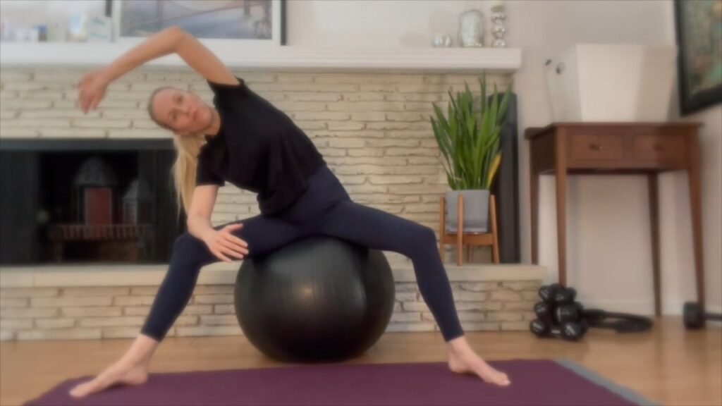 Woman stretching with Pilates ball