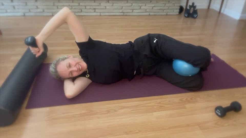 woman doing pilates weights on her side