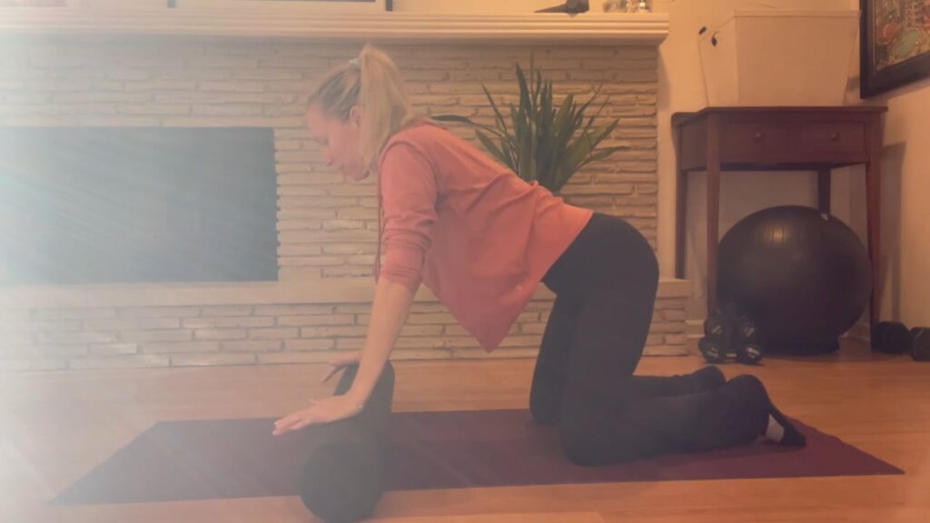 Woman doing Pilates with foam roller