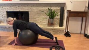 Woman doing Pilates on a ball.